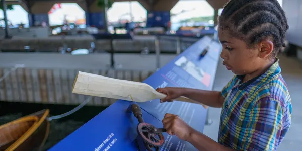 Child exploring interactive museum exhibits