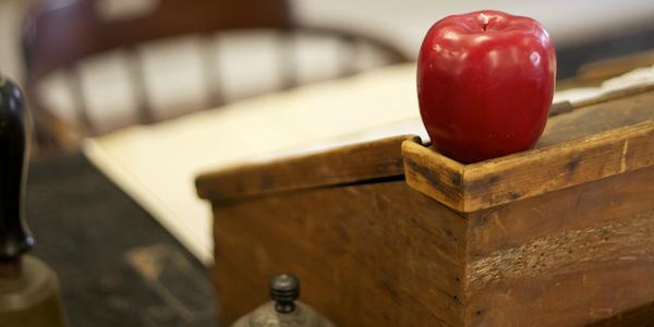 Apple on the corner of a hinged desk.